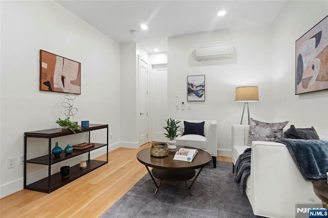 50 Grace St Unit 2R, Jersey City, NJ 07307 - living room with a wall mounted AC, wood finished floors, recessed lighting, and baseboards
