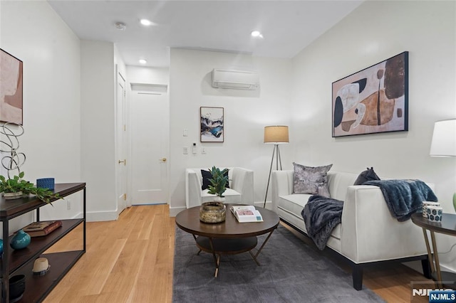 50 Grace St Unit 2R, Jersey City, NJ 07307 - living room with light wood-type flooring, recessed lighting, a wall unit AC, and baseboards