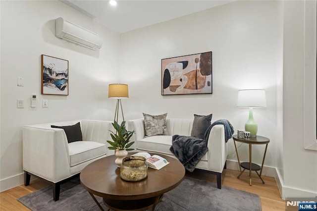 50 Grace St Unit 2R, Jersey City, NJ 07307 - sitting room with a wall unit AC, light wood-type flooring, and baseboards