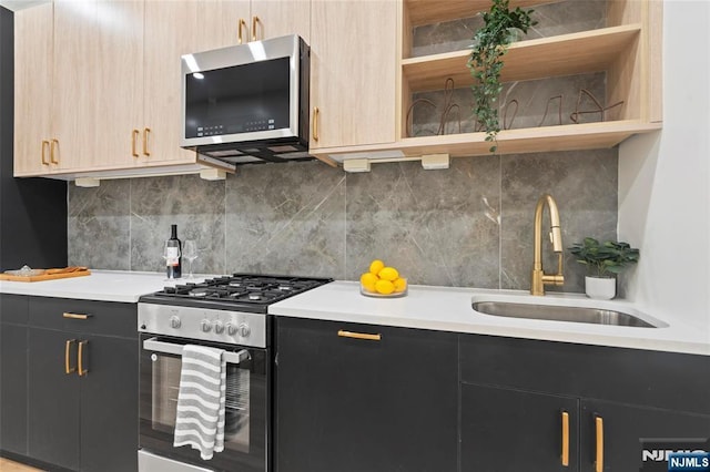 50 Grace St Unit 2R, Jersey City, NJ 07307 - kitchen with appliances with stainless steel finishes, a sink, light countertops, dark cabinetry, and tasteful backsplash