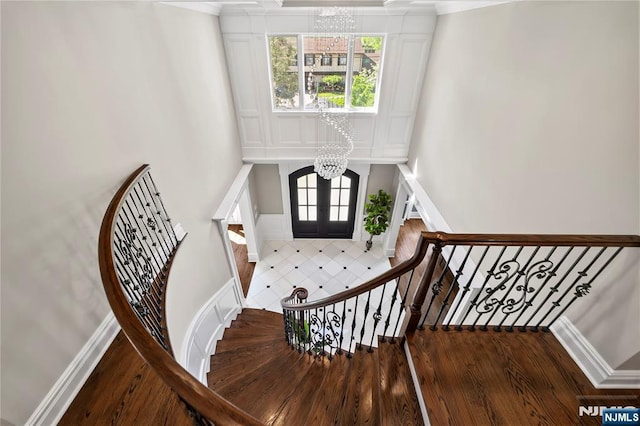 504 Kendrick St, Paramus, NJ 07652 - stairs featuring a chandelier, wood finished floors, a towering ceiling, crown molding, and baseboards