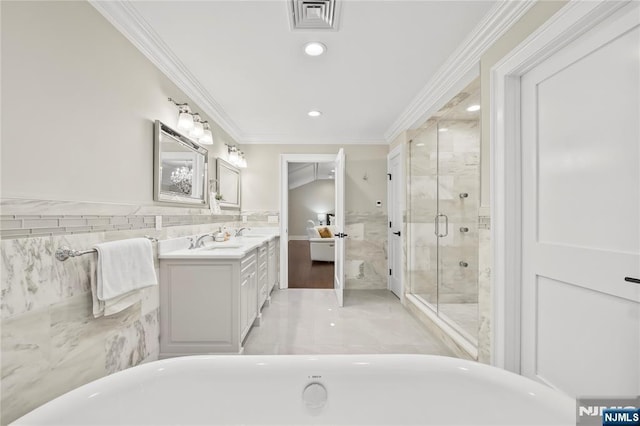 504 Kendrick St, Paramus, NJ 07652 - ensuite bathroom featuring crown molding, vanity, a freestanding bath, a stall shower, and tile walls