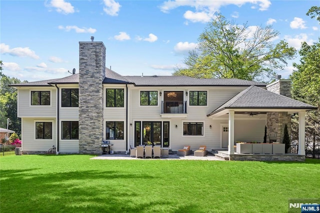 504 Kendrick St, Paramus, NJ 07652 - back of property with an outdoor living space, a chimney, a balcony, a patio, and a ceiling fan