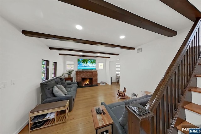 107 Elm St, West Orange, NJ 07052 - living room with recessed lighting, beamed ceiling, a fireplace, stairs, and light wood-type flooring