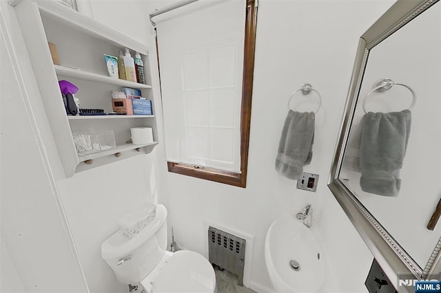 107 Elm St, West Orange, NJ 07052 - bathroom featuring radiator heating unit, toilet, and a sink
