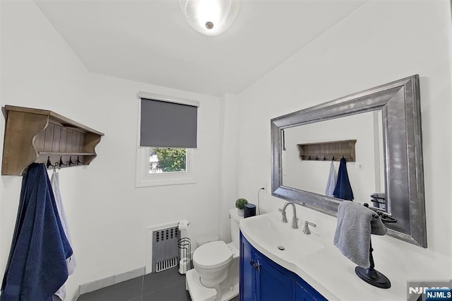 107 Elm St, West Orange, NJ 07052 - bathroom featuring vanity, toilet, tile patterned flooring, and radiator