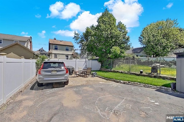 107 Elm St, West Orange, NJ 07052 - view of parking / parking lot with a fenced backyard