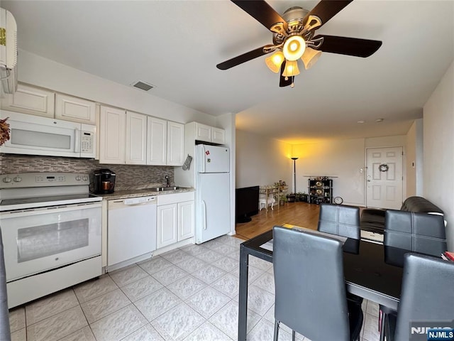201 12th St Unit 20, Palisades Park, NJ 07650 - kitchen featuring white appliances, a sink, backsplash, white cabinetry, and ceiling fan
