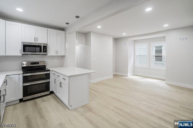 90 N Grove St, East Orange, NJ 07017 - kitchen featuring appliances with stainless steel finishes, a peninsula, light wood finished floors, baseboards, and light stone countertops