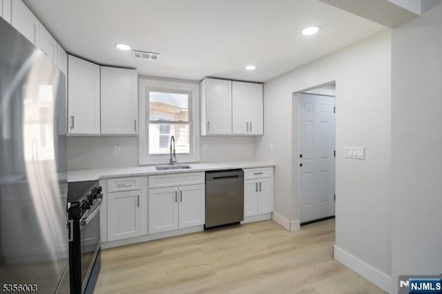 90 N Grove St, East Orange, NJ 07017 - kitchen featuring appliances with stainless steel finishes, a sink, light countertops, light wood-style floors, and recessed lighting