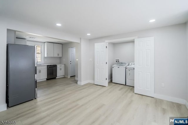 90 N Grove St, East Orange, NJ 07017 - kitchen featuring freestanding refrigerator, dishwasher, washing machine and dryer, light wood finished floors, and recessed lighting