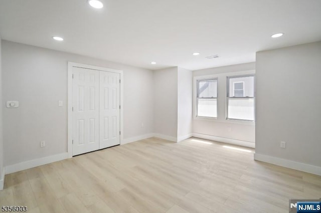 90 N Grove St, East Orange, NJ 07017 - unfurnished bedroom featuring light wood-style floors, recessed lighting, baseboards, and a closet