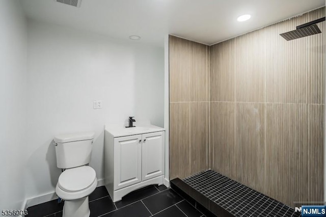 90 N Grove St, East Orange, NJ 07017 - bathroom with toilet, tiled shower, tile patterned flooring, and vanity