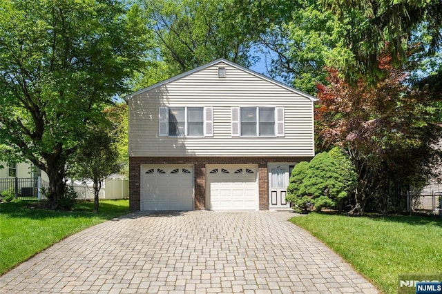 67 Short Pl, Cresskill, NJ 07626 - view of front of property with brick siding, decorative driveway, and an attached garage