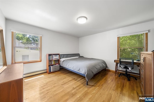 67 Short Pl, Cresskill, NJ 07626 - bedroom featuring baseboard heating, light wood-style flooring, and multiple windows