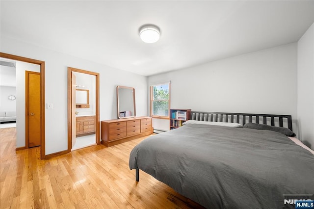 67 Short Pl, Cresskill, NJ 07626 - bedroom featuring light wood finished floors, baseboard heating, baseboards, and connected bathroom