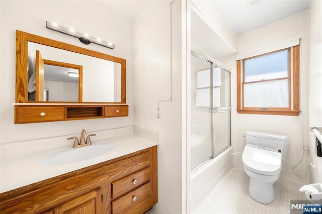 67 Short Pl, Cresskill, NJ 07626 - bathroom with toilet, vanity, bath / shower combo with glass door, and tile patterned floors