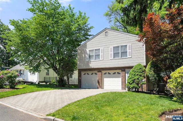 67 Short Pl, Cresskill, NJ 07626 - view of front of property with a garage, decorative driveway, brick siding, and central AC