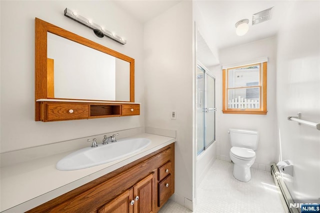 67 Short Pl, Cresskill, NJ 07626 - bathroom with vanity, baseboard heating, toilet, tile patterned floors, and bath / shower combo with glass door