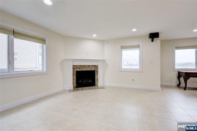 2 Jacobs Lndg, Secaucus, NJ 07094 - unfurnished living room featuring a fireplace, recessed lighting, baseboards, and light tile patterned floors