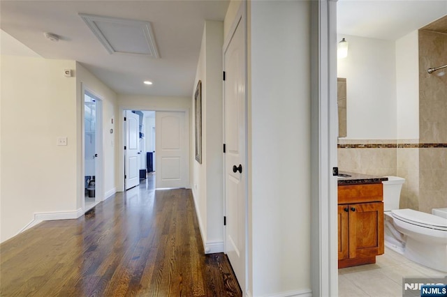 2 Jacobs Lndg, Secaucus, NJ 07094 - hall featuring attic access, tile walls, wood finished floors, and wainscoting