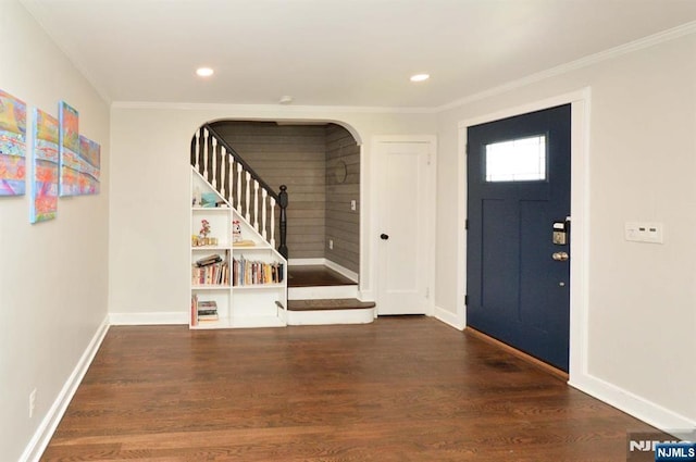 710 Ramapo Rd, Teaneck, NJ 07666 - entryway with stairs, wood finished floors, ornamental molding, arched walkways, and baseboards