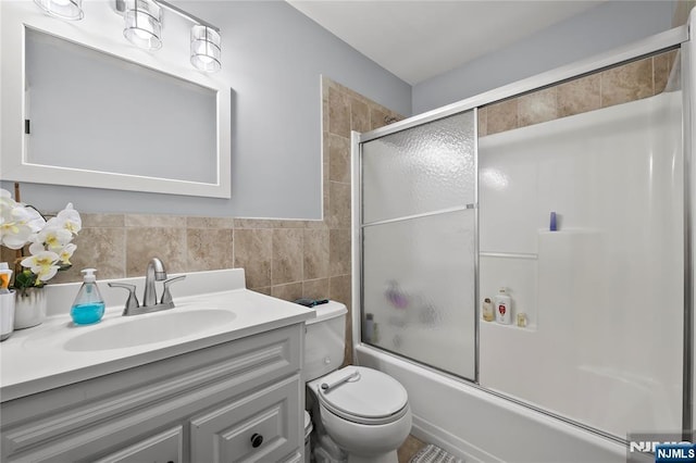 15 Kossuth St, Wallington, NJ 07057 - full bathroom featuring vanity, tile walls, bath / shower combo with glass door, and toilet