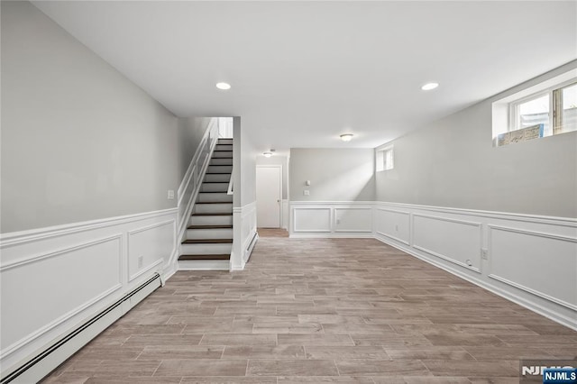 15 Kossuth St, Wallington, NJ 07057 - below grade area featuring baseboard heating, recessed lighting, light wood finished floors, stairs, and a decorative wall