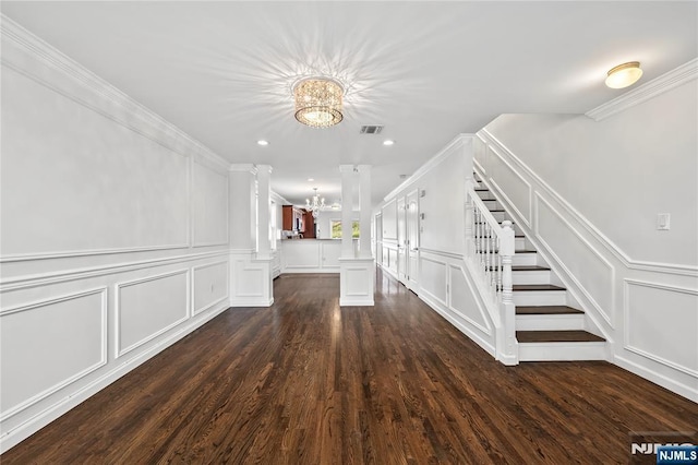 15 Kossuth St, Wallington, NJ 07057 - empty room featuring a chandelier, a decorative wall, stairway, decorative columns, and dark wood finished floors