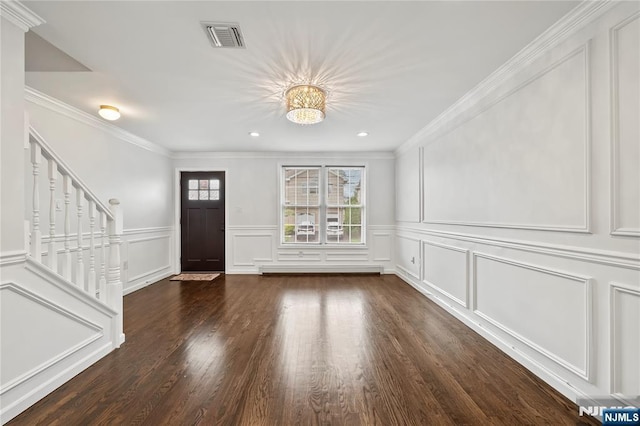 15 Kossuth St, Wallington, NJ 07057 - foyer entrance with a decorative wall, stairway, a chandelier, crown molding, and wood finished floors