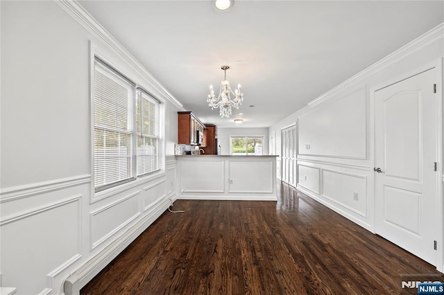 15 Kossuth St, Wallington, NJ 07057 - unfurnished dining area with a chandelier, a decorative wall, ornamental molding, dark wood-type flooring, and a wainscoted wall