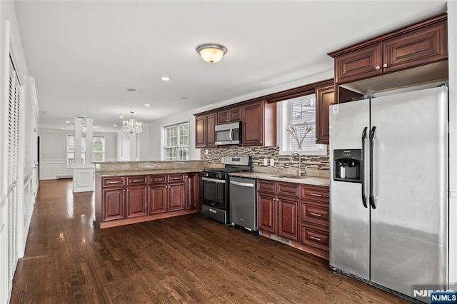15 Kossuth St, Wallington, NJ 07057 - kitchen featuring appliances with stainless steel finishes, a sink, a peninsula, a chandelier, and dark wood-style floors