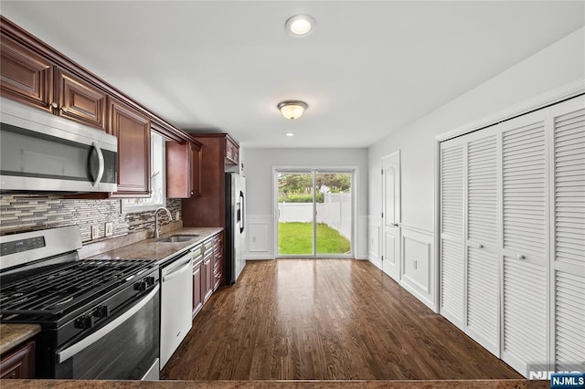 15 Kossuth St, Wallington, NJ 07057 - kitchen with stainless steel appliances, a sink, dark wood-style floors, backsplash, and wainscoting