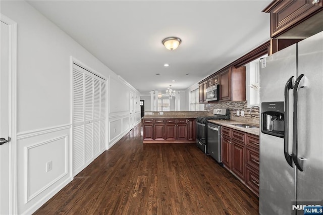 15 Kossuth St, Wallington, NJ 07057 - kitchen featuring appliances with stainless steel finishes, a sink, a peninsula, a chandelier, and dark wood finished floors