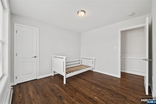 15 Kossuth St, Wallington, NJ 07057 - unfurnished bedroom featuring a baseboard radiator, wood finished floors, and baseboards
