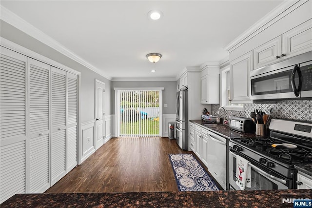 15 Kossuth St, Wallington, NJ 07057 - kitchen with stainless steel appliances, a sink, white cabinetry, dark wood-type flooring, and crown molding