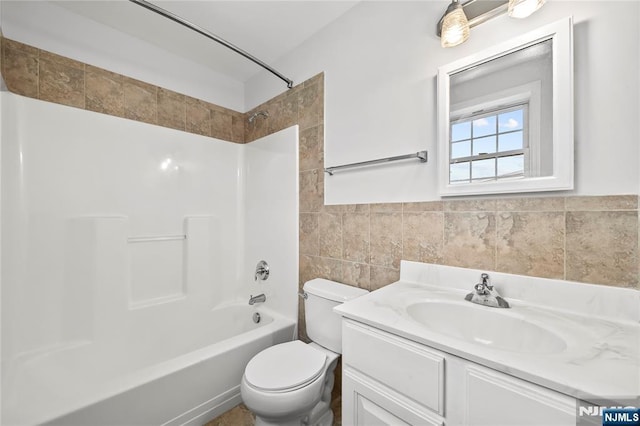 15 Kossuth St, Wallington, NJ 07057 - bathroom featuring tile walls, toilet, vanity, and washtub / shower combination
