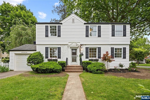 428 Elm Ave, River Edge, NJ 07661 - colonial-style house with a front lawn, an attached garage, and driveway