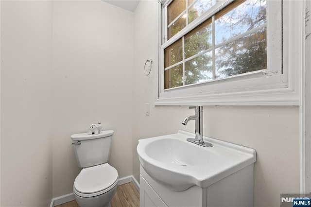 428 Elm Ave, River Edge, NJ 07661 - bathroom with vanity, toilet, wood finished floors, and baseboards