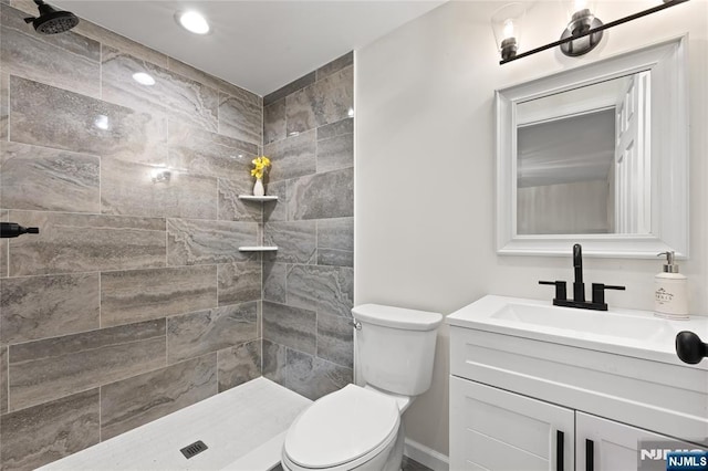 428 Elm Ave, River Edge, NJ 07661 - bathroom with vanity, tiled shower, toilet, and recessed lighting