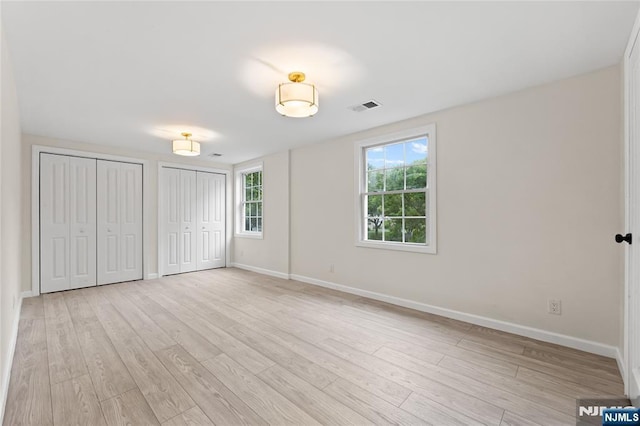 428 Elm Ave, River Edge, NJ 07661 - unfurnished bedroom featuring two closets, light wood finished floors, and baseboards