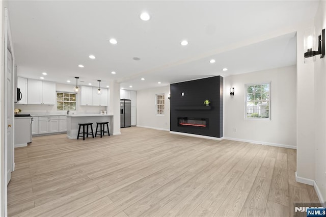 428 Elm Ave, River Edge, NJ 07661 - living room with light wood-type flooring, baseboards, a fireplace, and recessed lighting