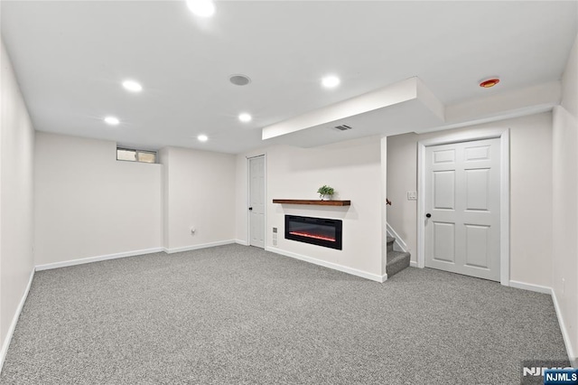 428 Elm Ave, River Edge, NJ 07661 - finished basement featuring carpet flooring, recessed lighting, baseboards, a glass covered fireplace, and stairs