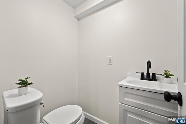 428 Elm Ave, River Edge, NJ 07661 - bathroom with toilet, vanity, and baseboards