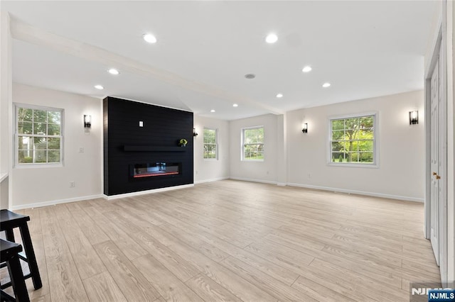 428 Elm Ave, River Edge, NJ 07661 - unfurnished living room with light wood finished floors, healthy amount of natural light, baseboards, a fireplace, and recessed lighting