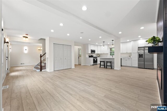 428 Elm Ave, River Edge, NJ 07661 - living room featuring stairs, recessed lighting, light wood finished floors, and baseboards
