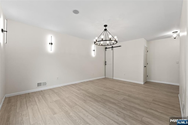 428 Elm Ave, River Edge, NJ 07661 - empty room featuring a chandelier, light wood-type flooring, and baseboards