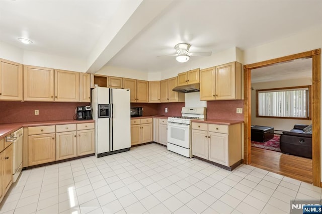 650 5th Ave, River Edge, NJ 07661 - kitchen with white appliances, under cabinet range hood, light brown cabinets, and ceiling fan