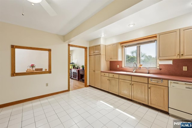 650 5th Ave, River Edge, NJ 07661 - kitchen featuring white dishwasher, a sink, tasteful backsplash, and light brown cabinetry