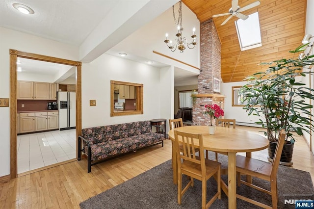 650 5th Ave, River Edge, NJ 07661 - dining area with light wood finished floors, a ceiling fan, a towering ceiling, recessed lighting, and a skylight
